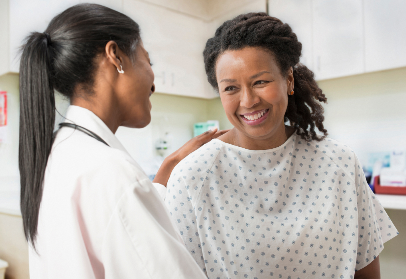 Female team member consult with patient in a gown