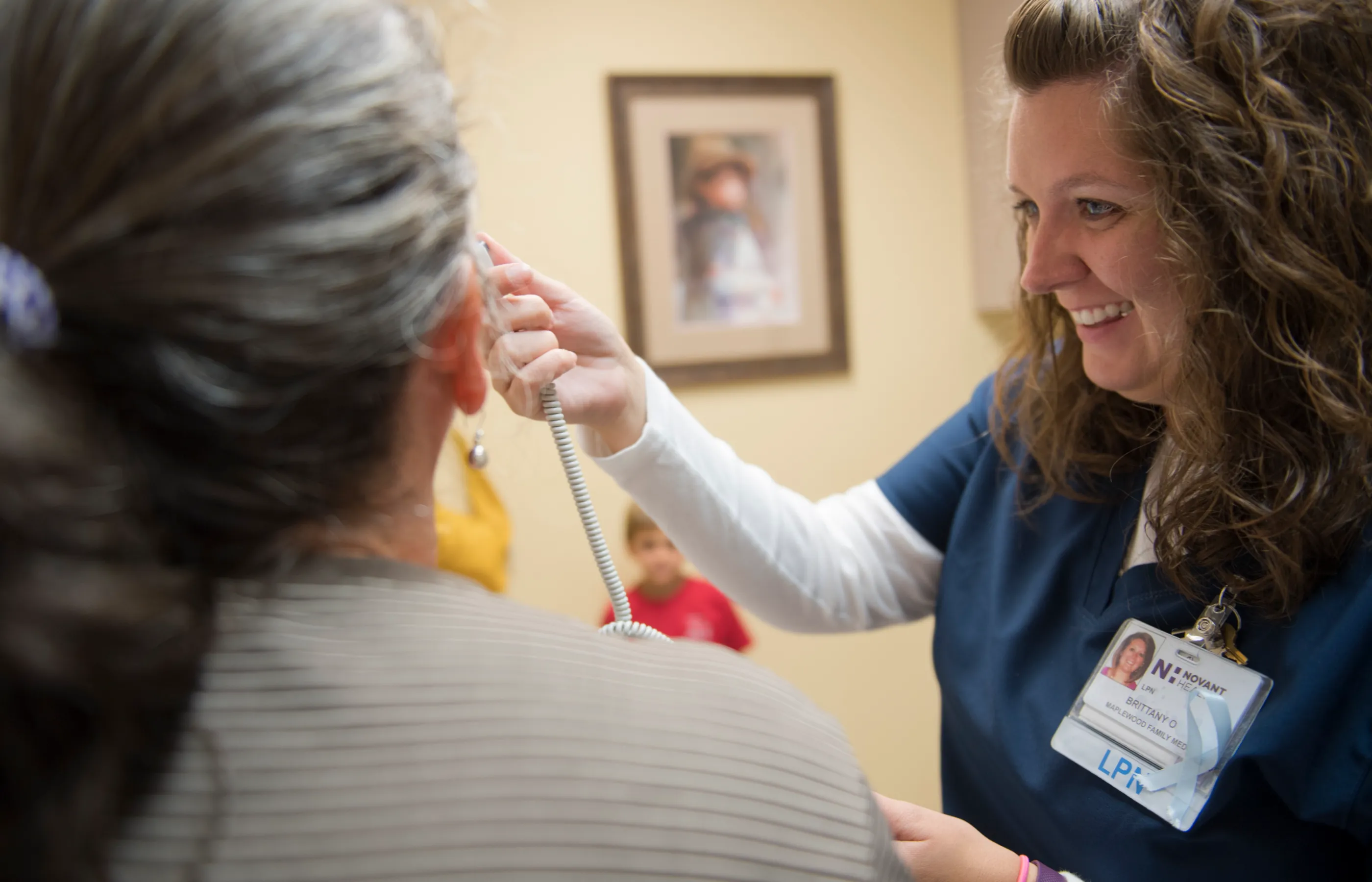 A nurse takes a women's temperature