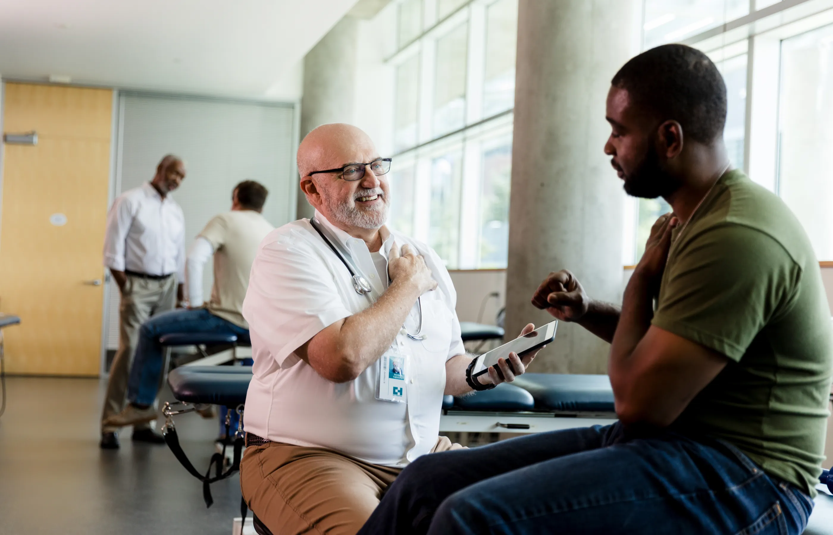 A group of men having physical therapy in a large room.