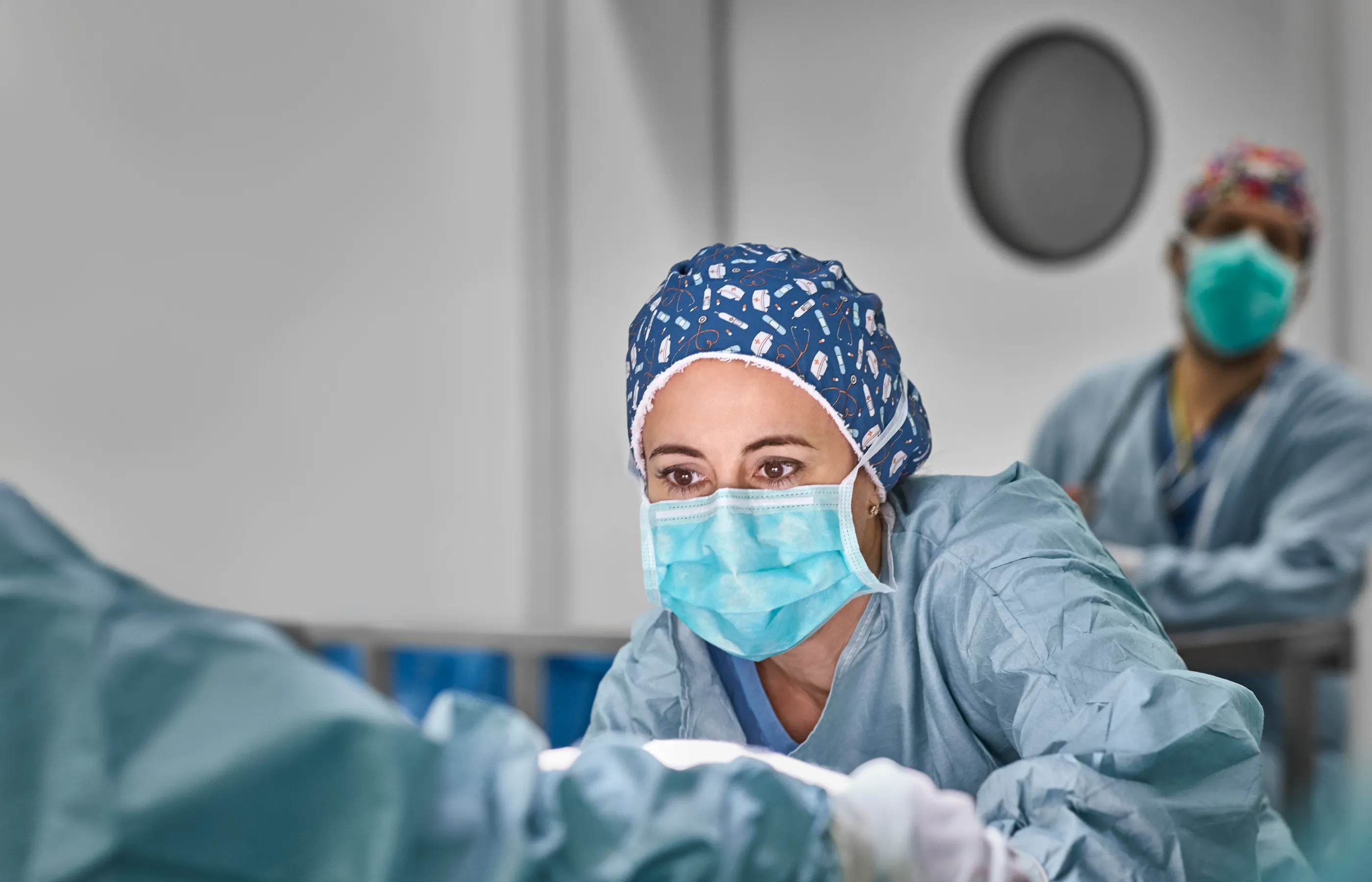 A healthcare provider is performing a procedure in an operating room. 