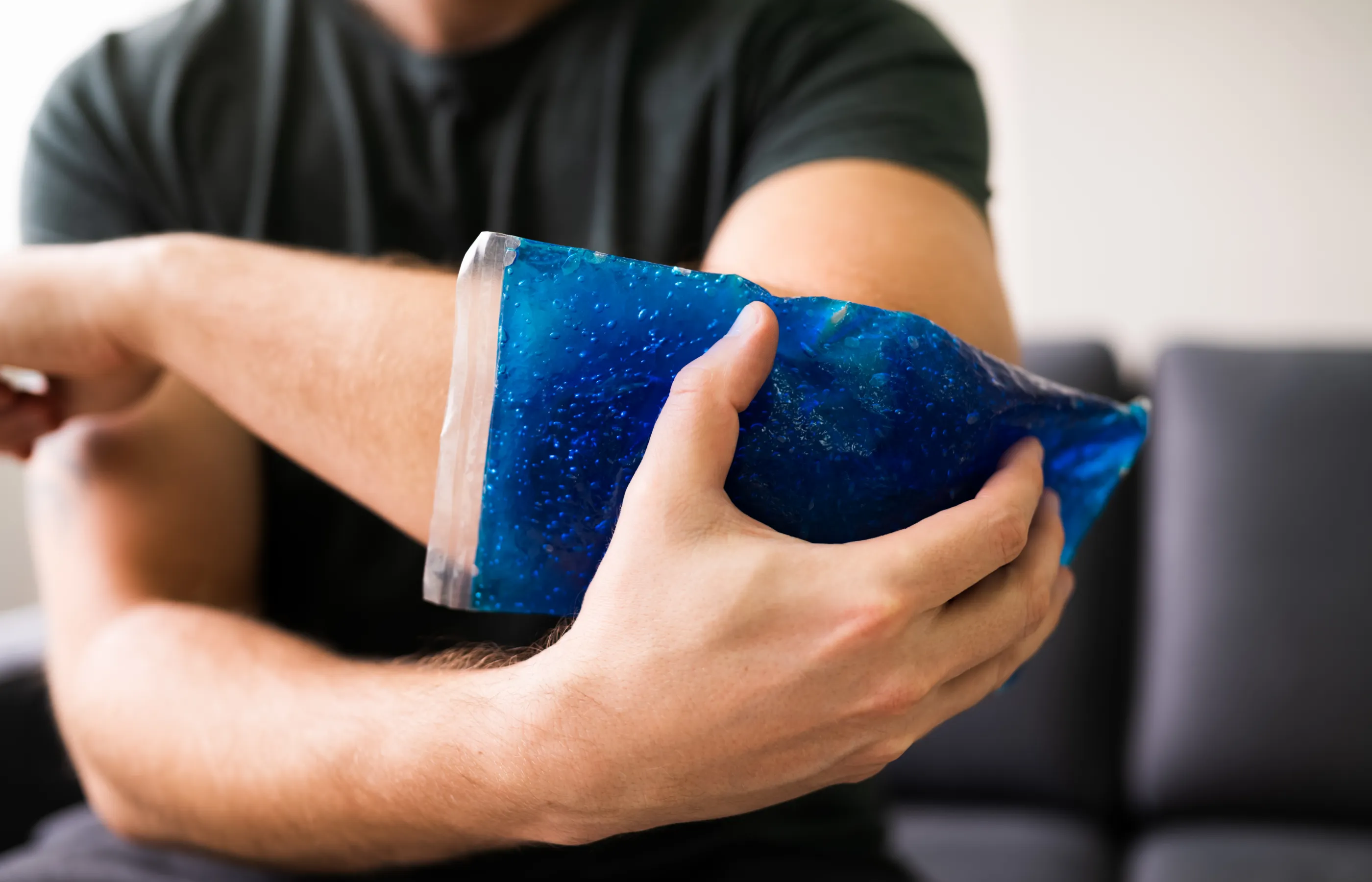 A person is holding an ice pack to their elbow
