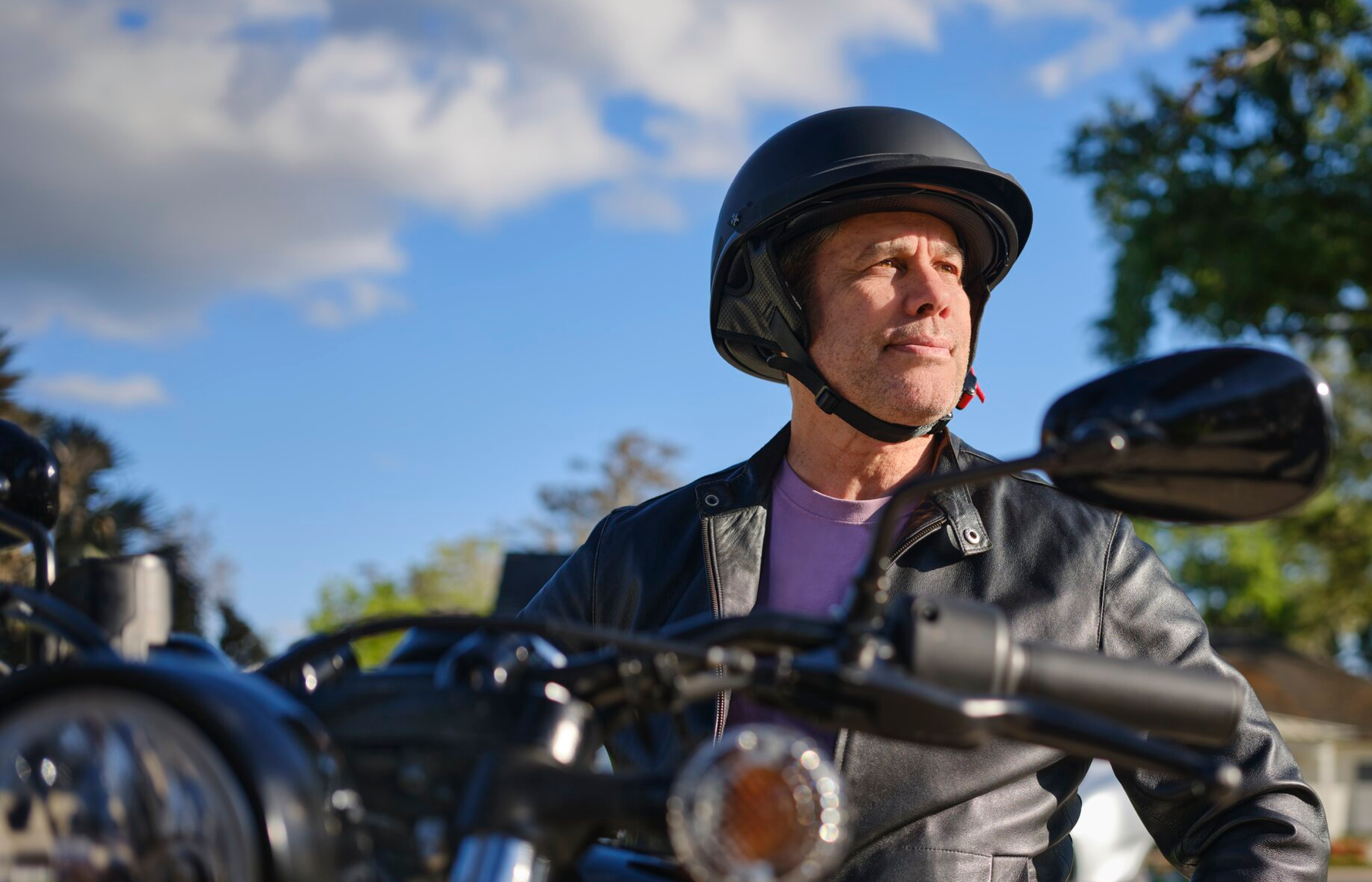 A man riding a motorcycle outdoors.