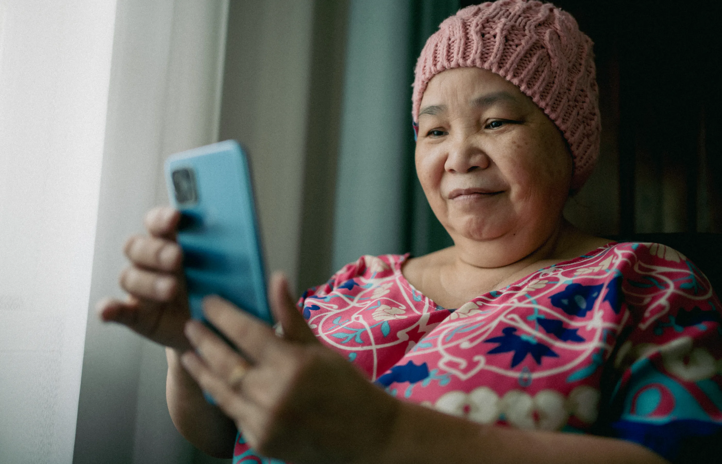 Cancer patient reading and reviewing information on her smartphone. 