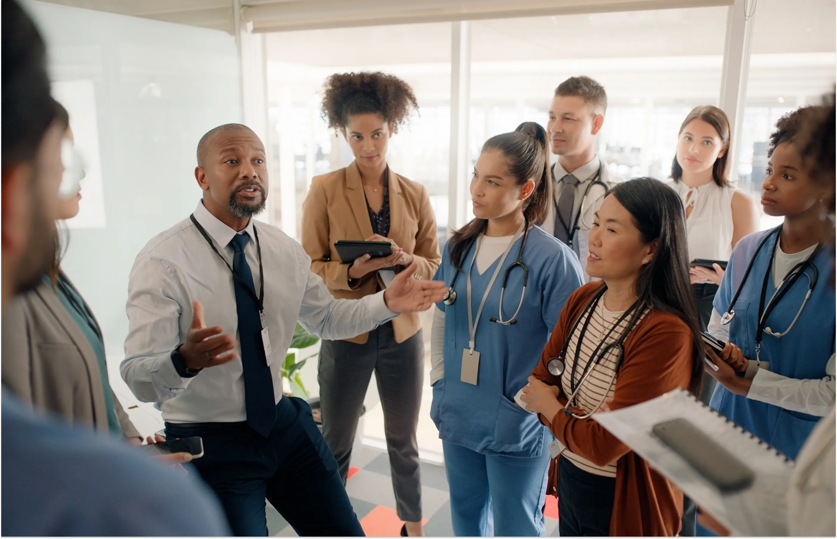Medical team members in a group talking with each other.