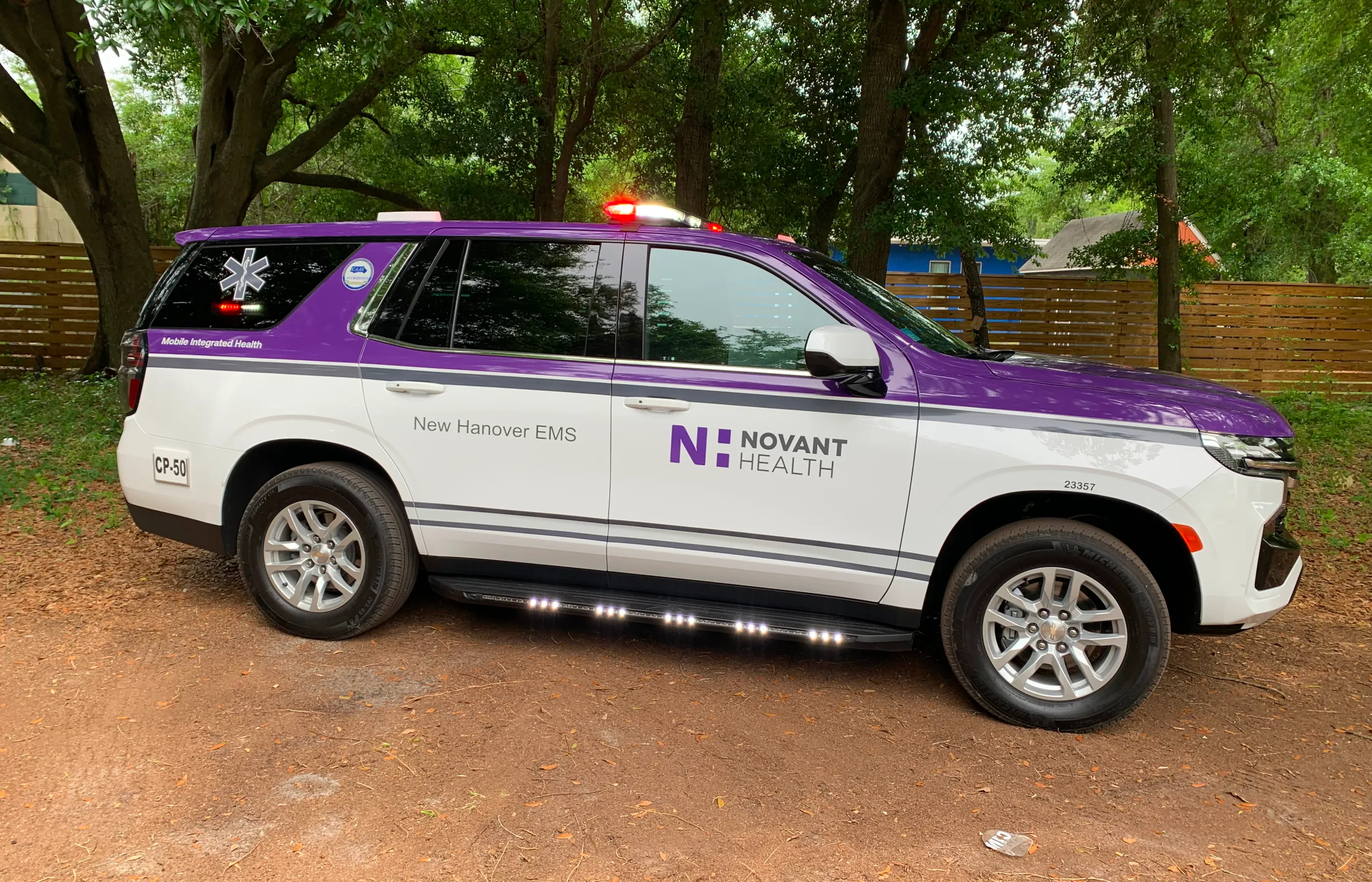 EMS community care truck parked in front of a building.