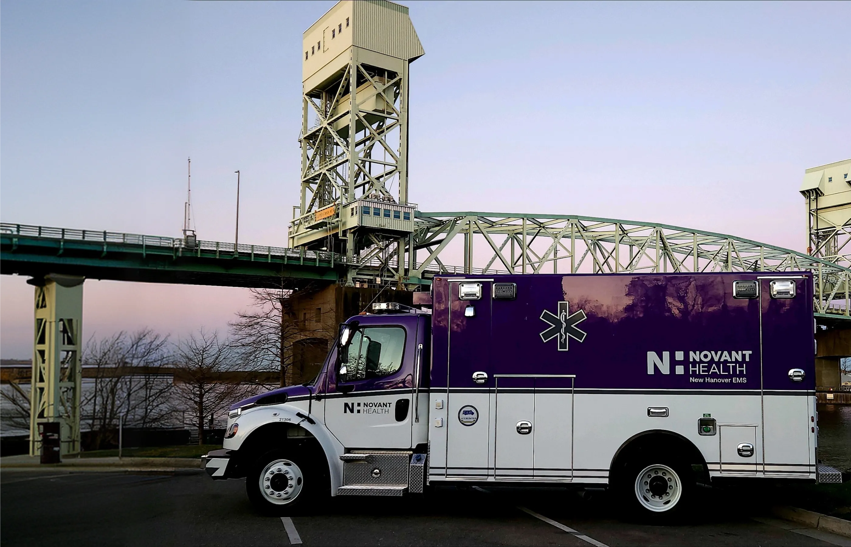 EMS Community Care truck parked in front of a bridge.