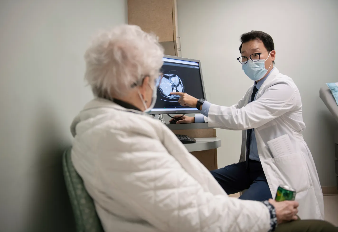 Dr. An is reviewing a scan with a patient.