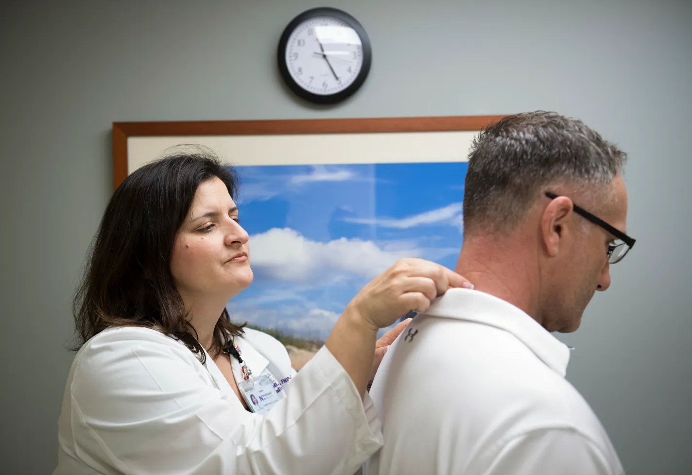 Dr. Mattoli examining a patients neck and spine. 