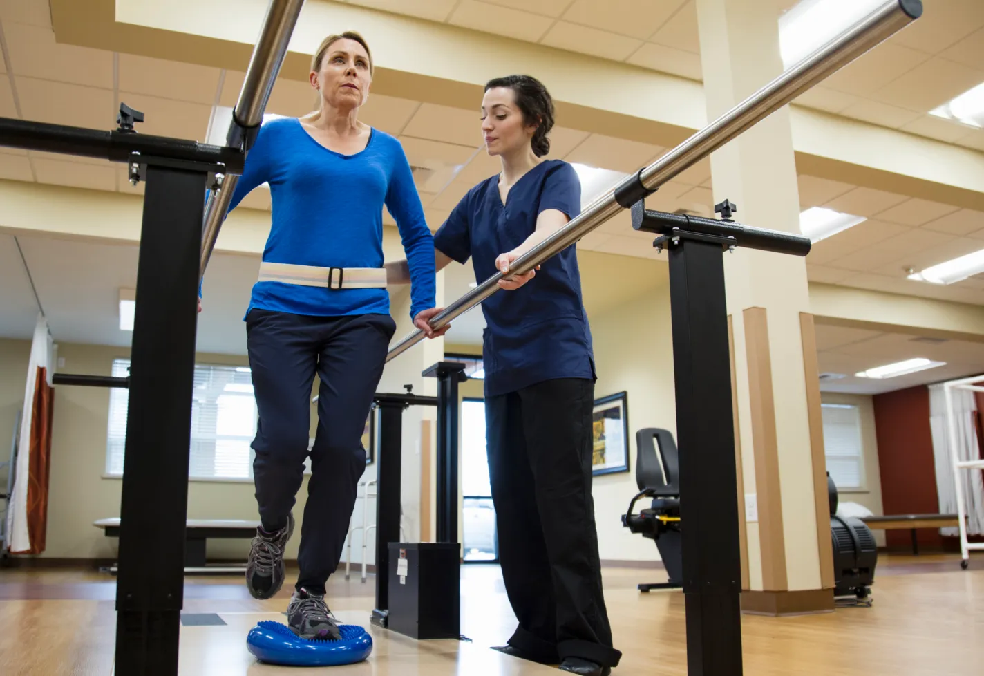 A Novant Health physical therapist is spotting a patient as they balance 