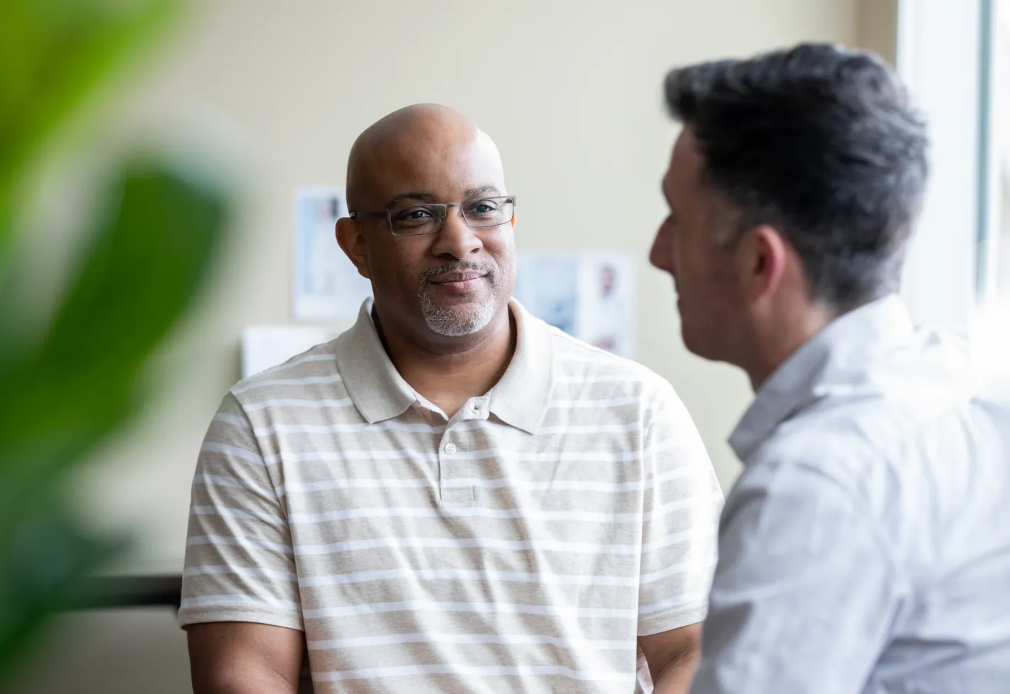 Male counselor talking with a middle aged patient 