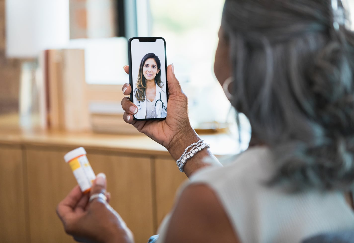 A woman discusses her prescription with her female physician on a virtual care call