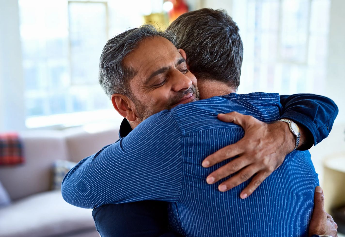 Two men hugging.