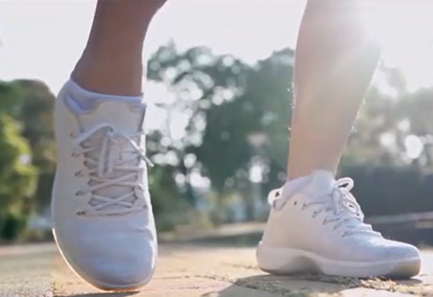 Close up view of feet in athletic shoes walking down an outdoor path