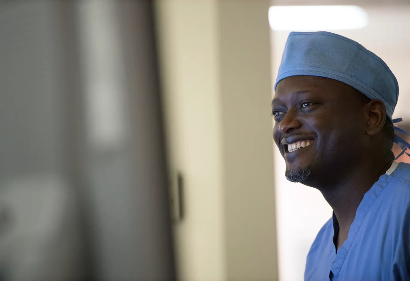 A Novant Health surgeon is dressed and ready for surgery and smiling. 
