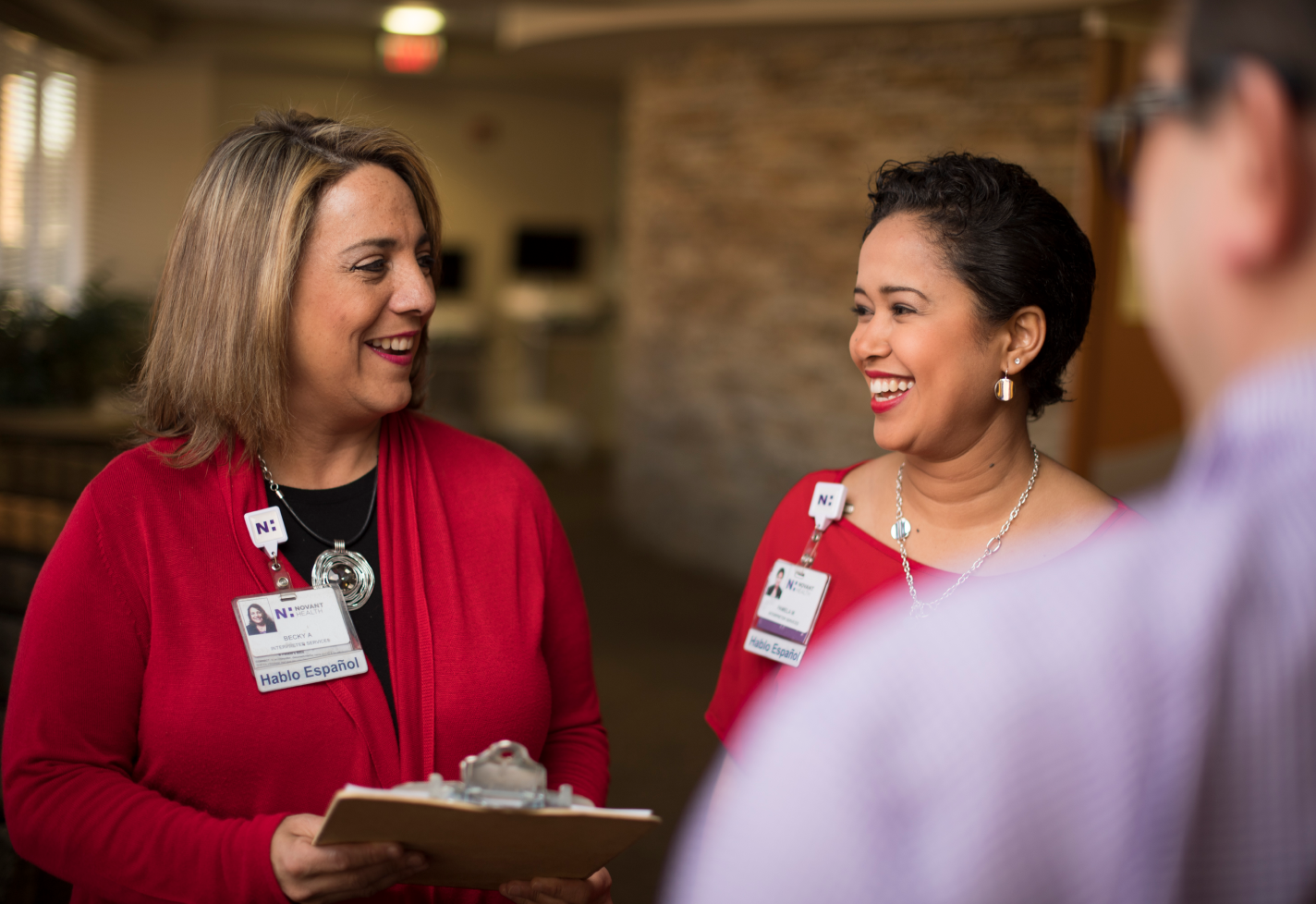 Two female team members from interpreter services speaking with each other.