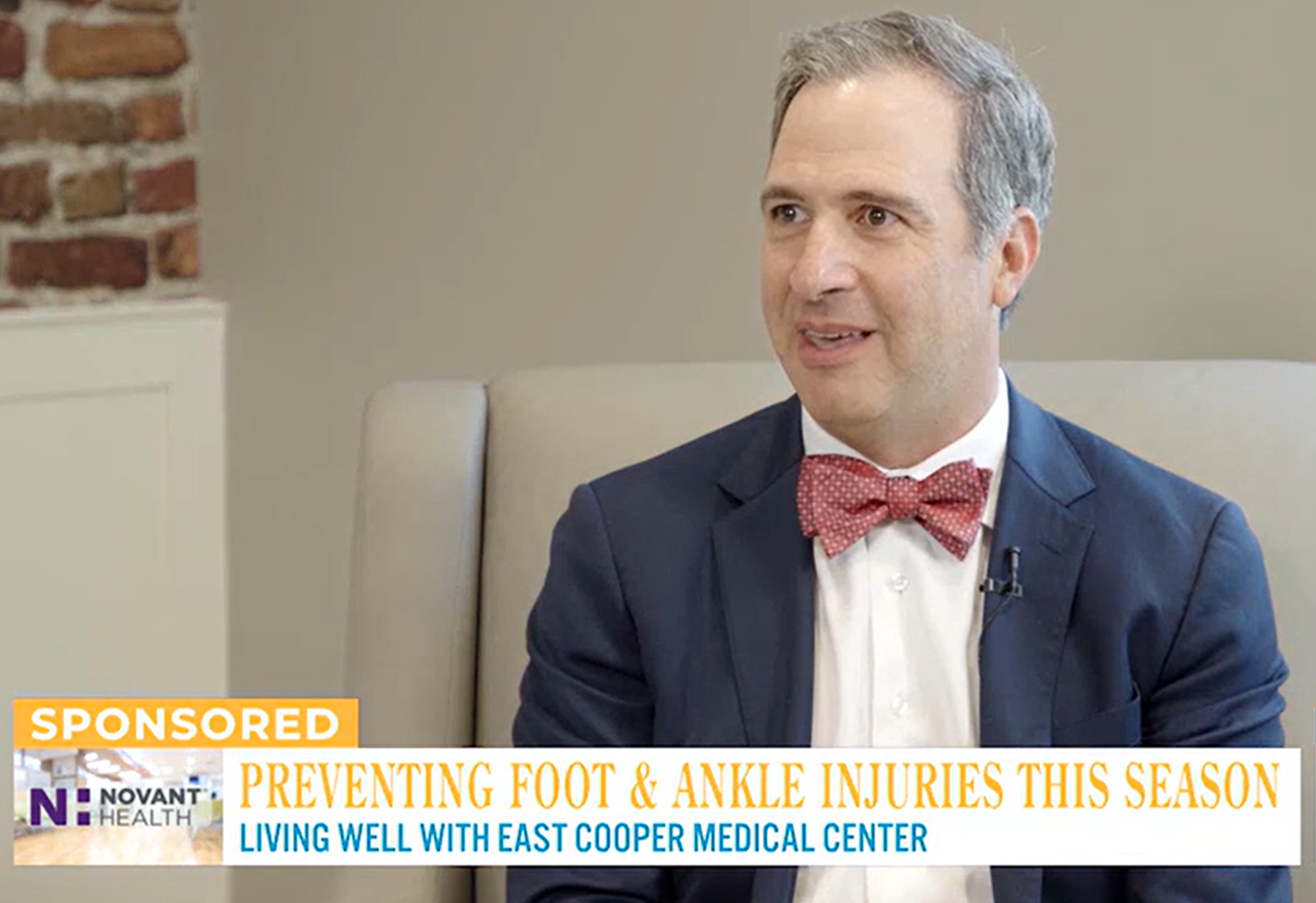 Dr. William Corey in a suit and bow tie discusses foot and ankle injury prevention on a television show.