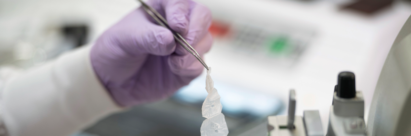 hands of a lab technician working with a test sample