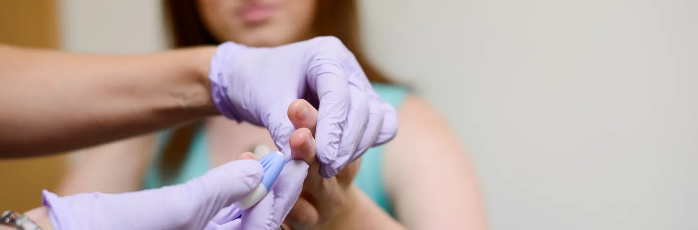 nurse takes a patient's blood sample