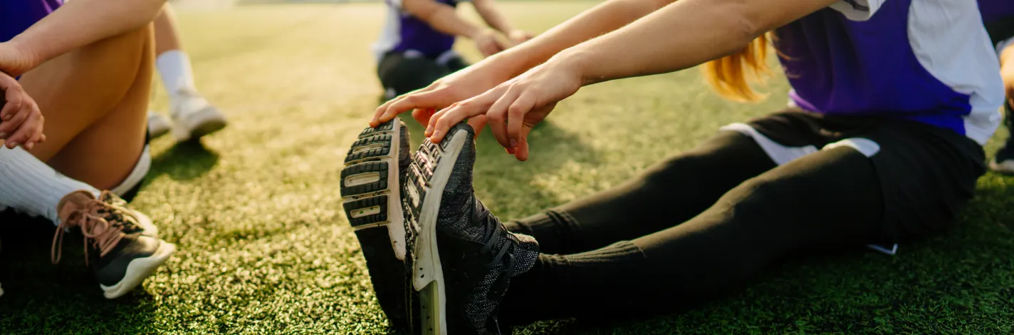 Close up of young women doing stretching exercise with running shoes