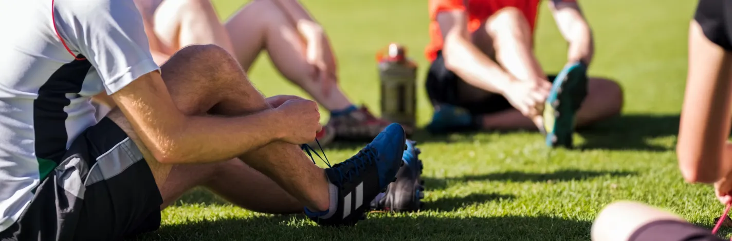 Soccer player tying his shoe before a match.