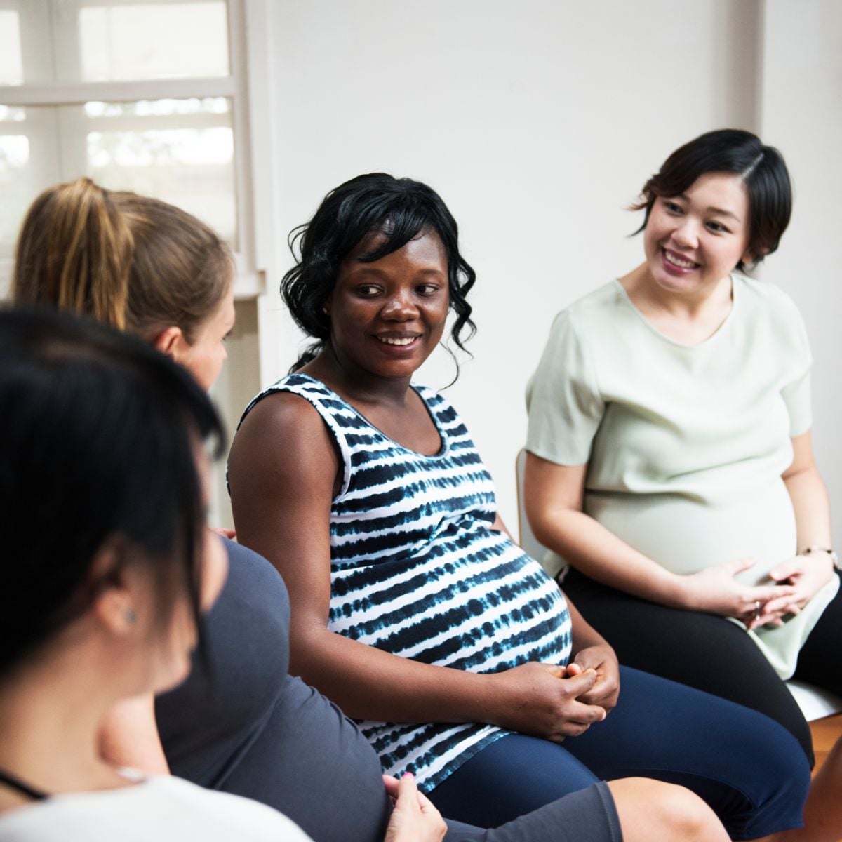 Moms smiling encouragingly at a Novant Health support group