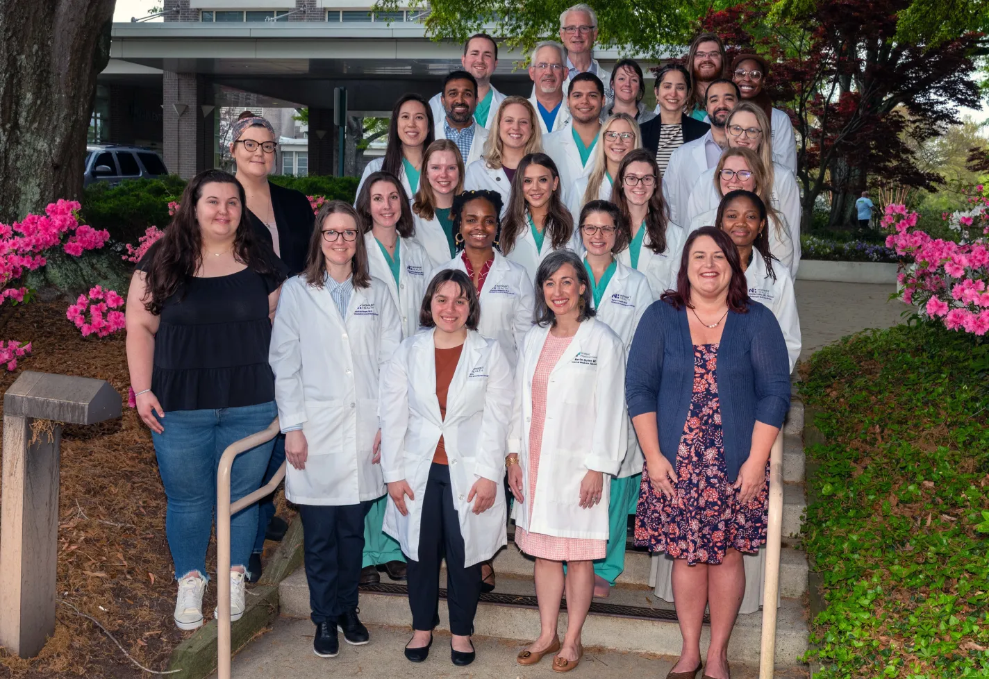 Wilmington ob-gyn residents and faculty in white coats at graduation