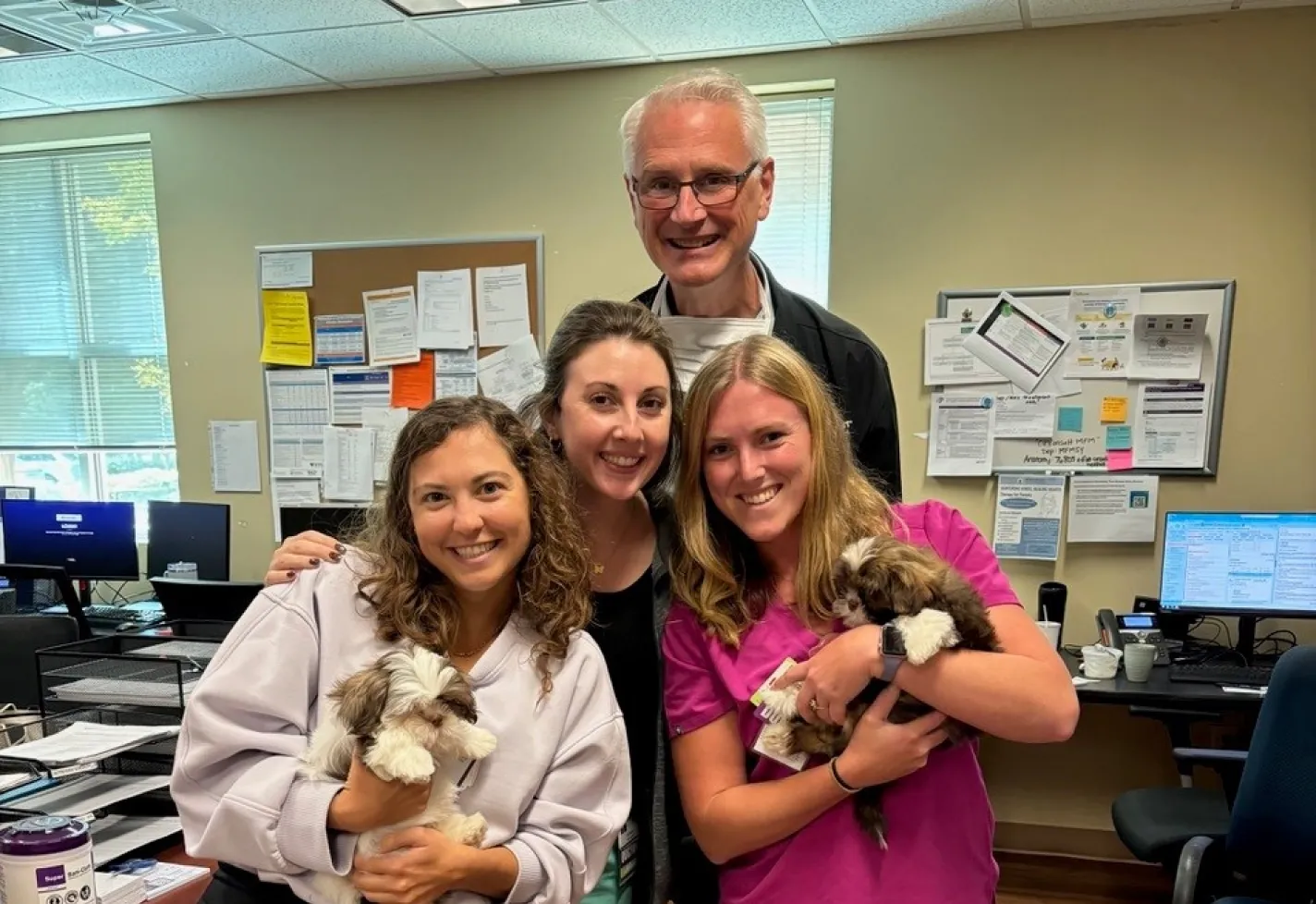 Wilmington, NC ob-gyn residents playing with puppies