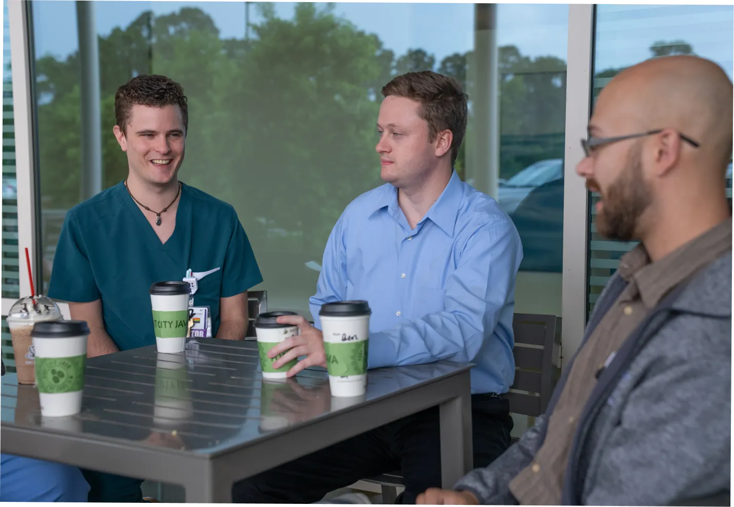 Wilmington, NC psychiatry residents seated at a table talking over coffee