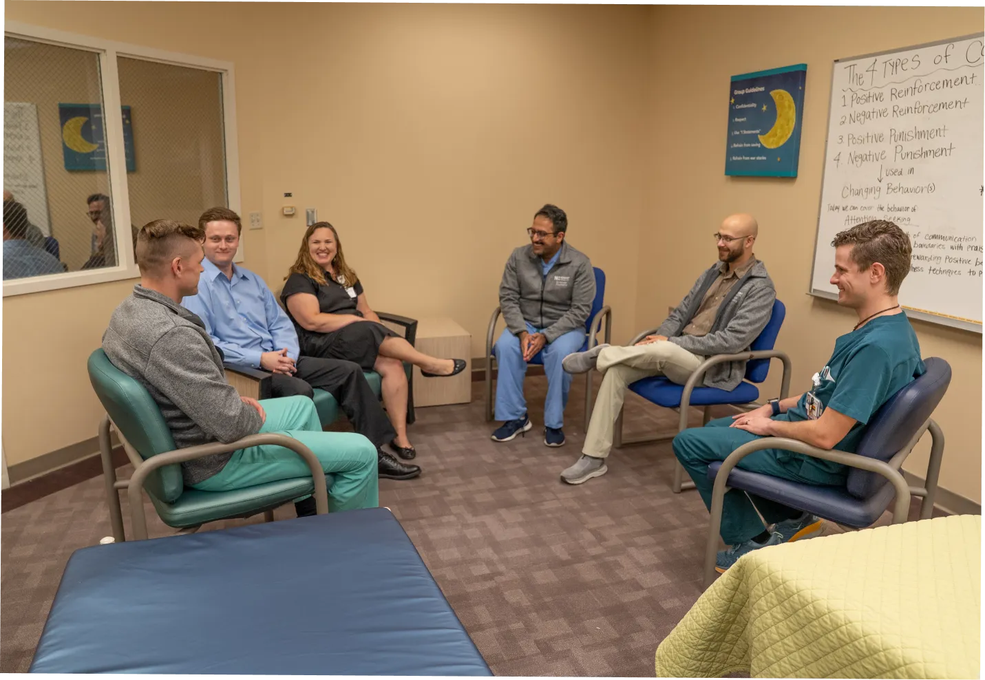 Psychiatry residency faculty in Wilmington, NC teaching group of residents in a circle