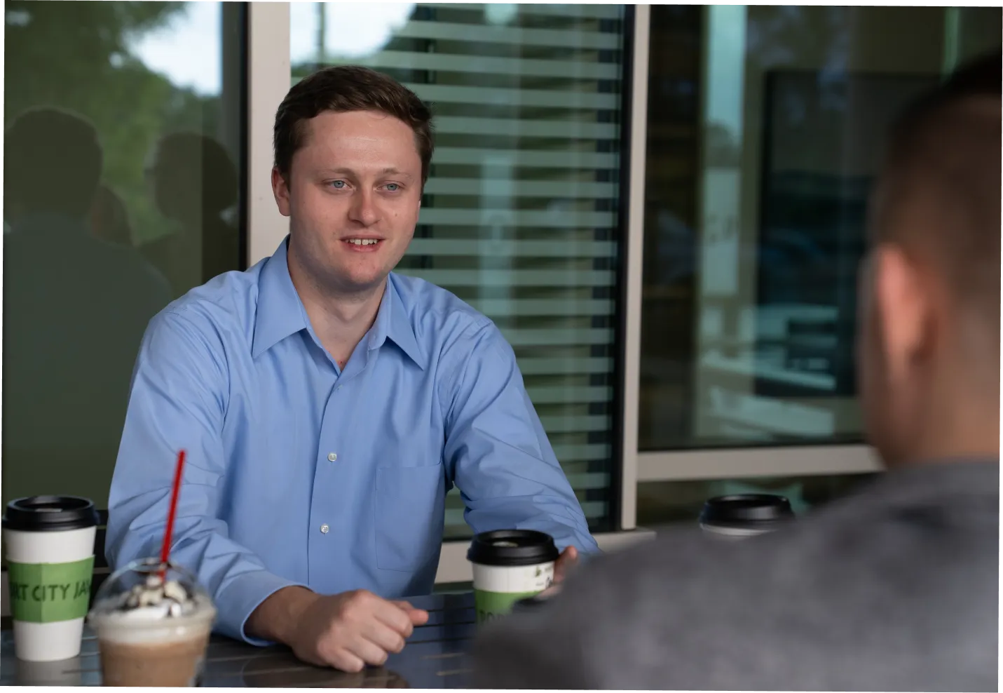 Wilmington, NC psychiatry resident seated talking over coffee