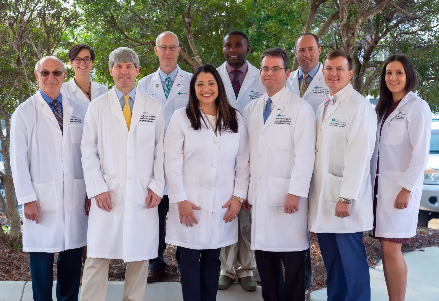 Wilmington surgery residents and faculty in white coats at graduation