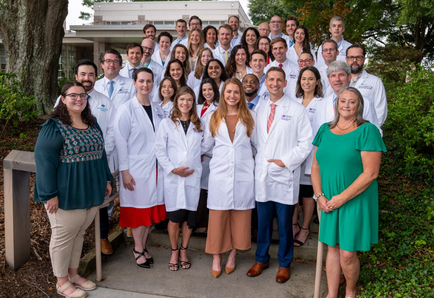Wilmington surgery residents and faculty in white coats at graduation