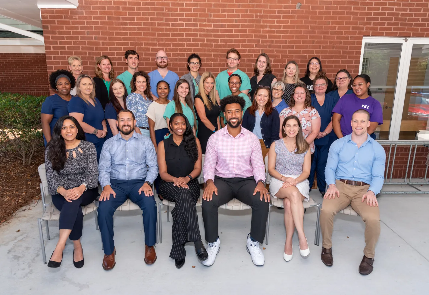 Group of Wilmington family medicine residents seated at graduation