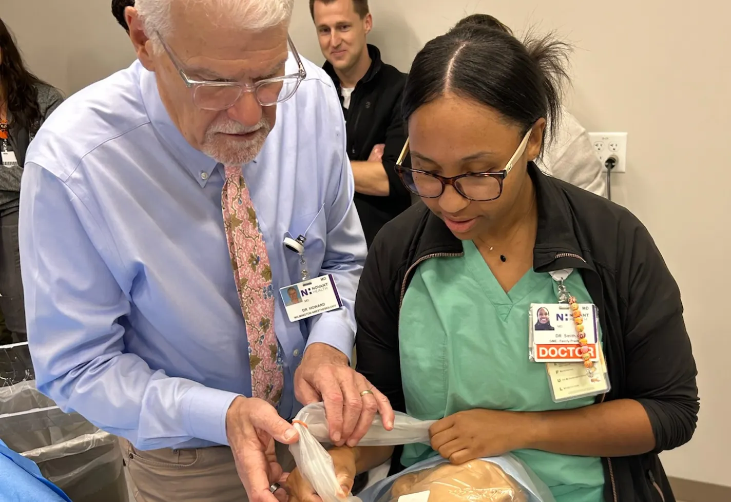 Family medicine residency faculty instructing a resident using a dummy
