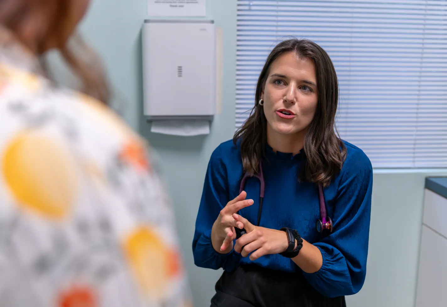 Novant Health Wilmington rural family medicine resident in a clinic talking with a patient