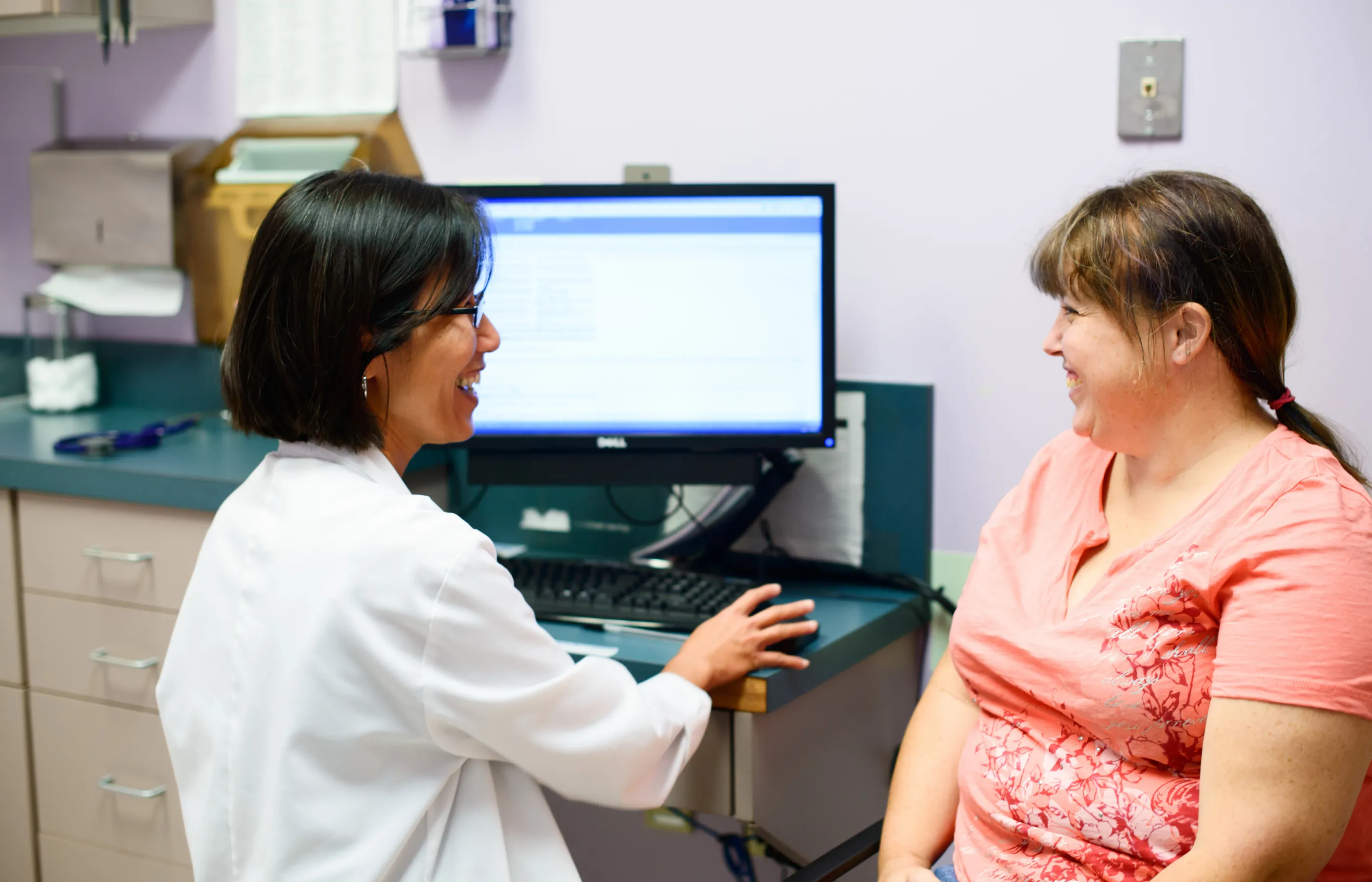 Doctor and woman at a clinical computer Doctor and woman at a clinical computer