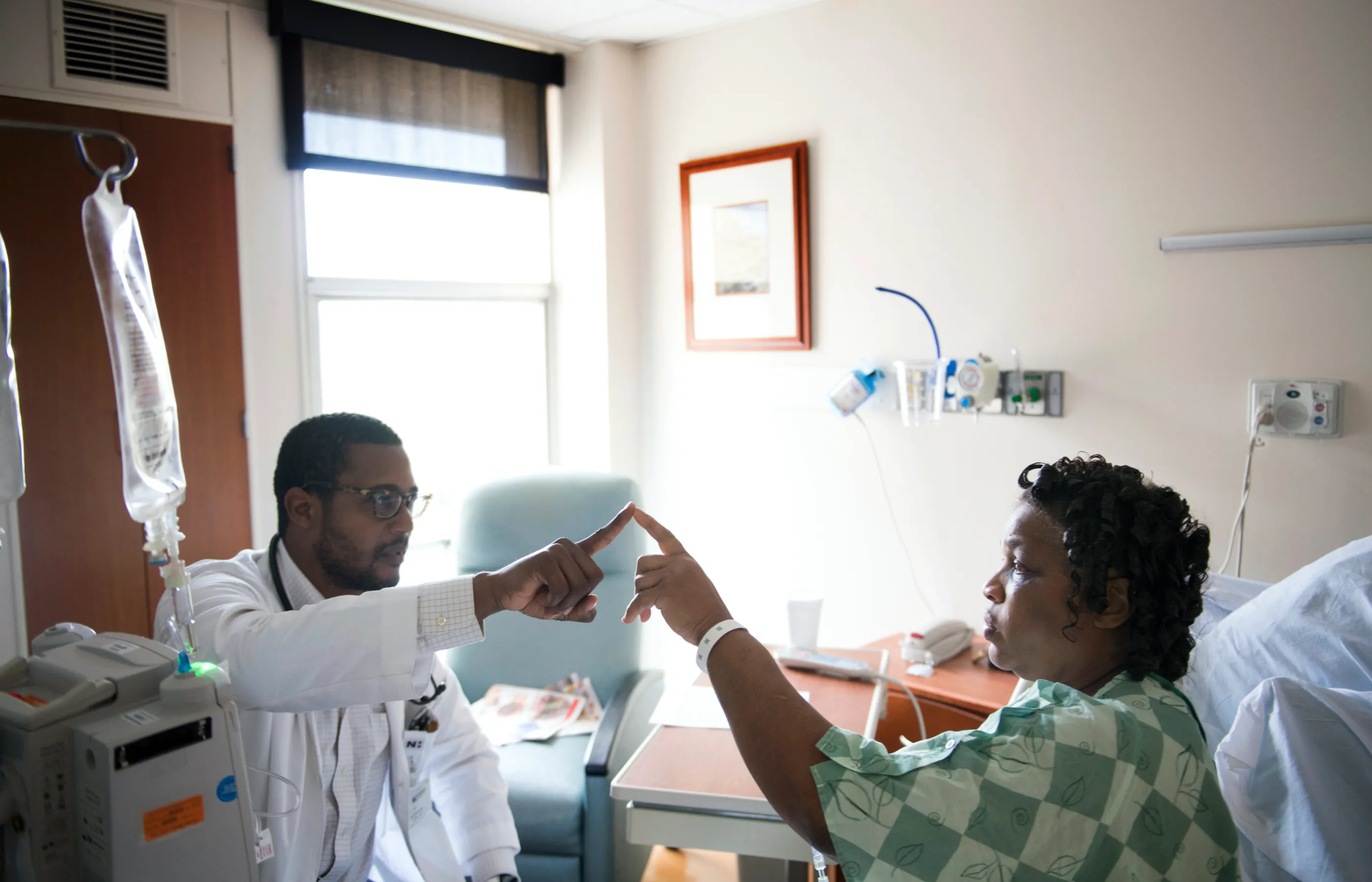 Physicians testing a woman patient's response Physicians testing a woman patient's response