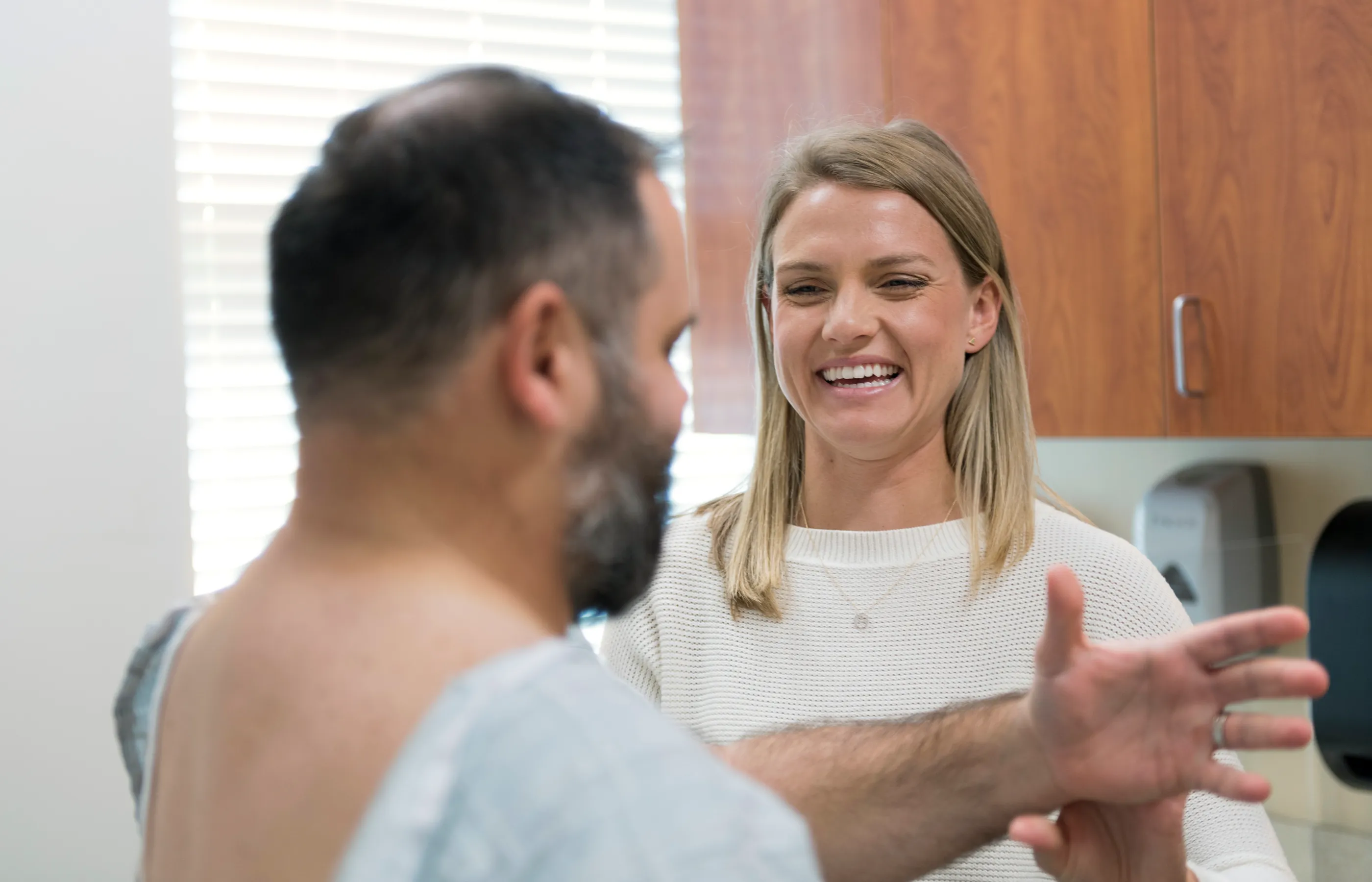 Novant Health's Doctor Jennifer Susanne Harvey treating patient's shoulder.