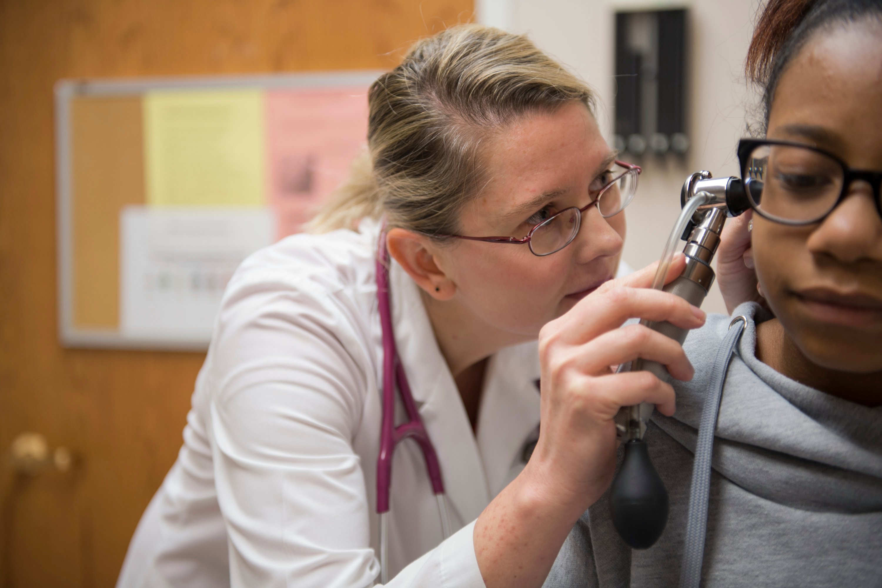 Dr. Magdalena Bilska is looking into the ear of a young patient.  Dr. Magdalena Bilska is looking into the ear of a young patient.