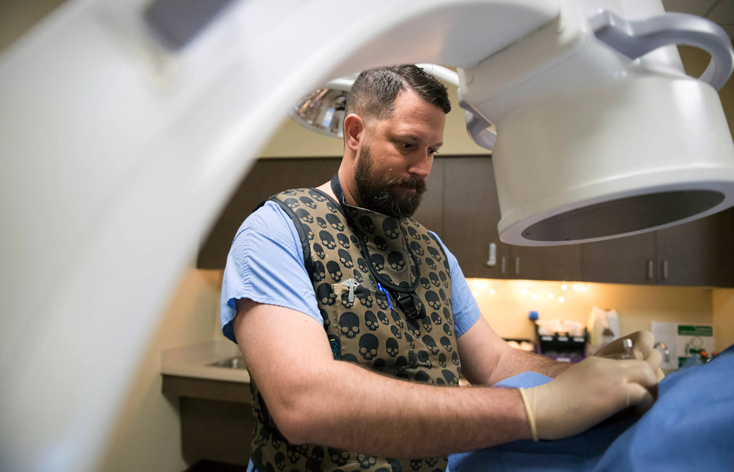 Dr. Peacock performing a procedure on patient with neurology technology. 