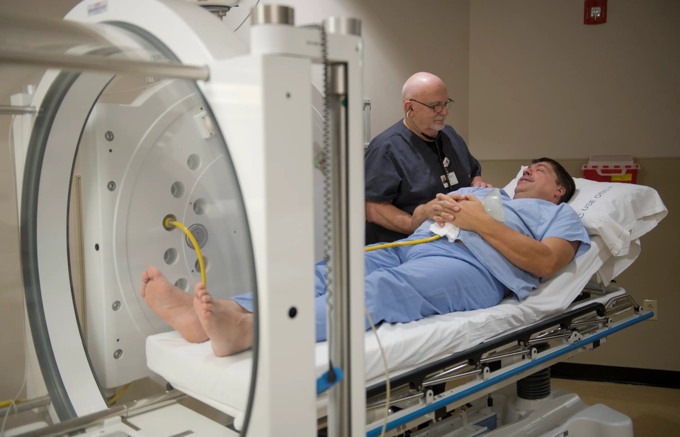 Dr. Wassel smiles at a patient after prepping the patient for hyperbaric oxygen therapy