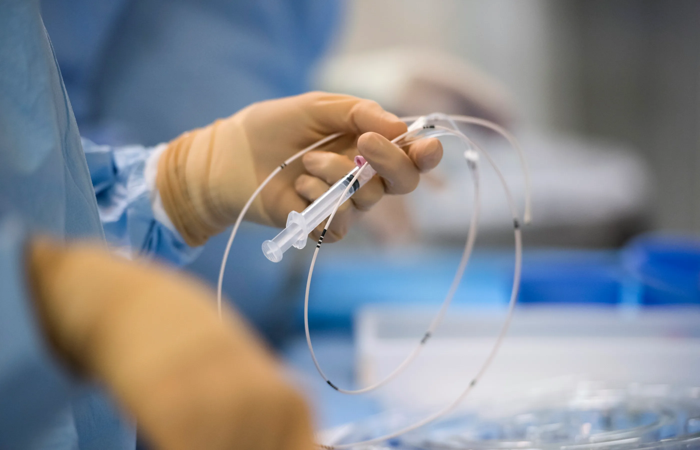 A Novant Health team member is preparing tubing devices for surgery in an operating room. 