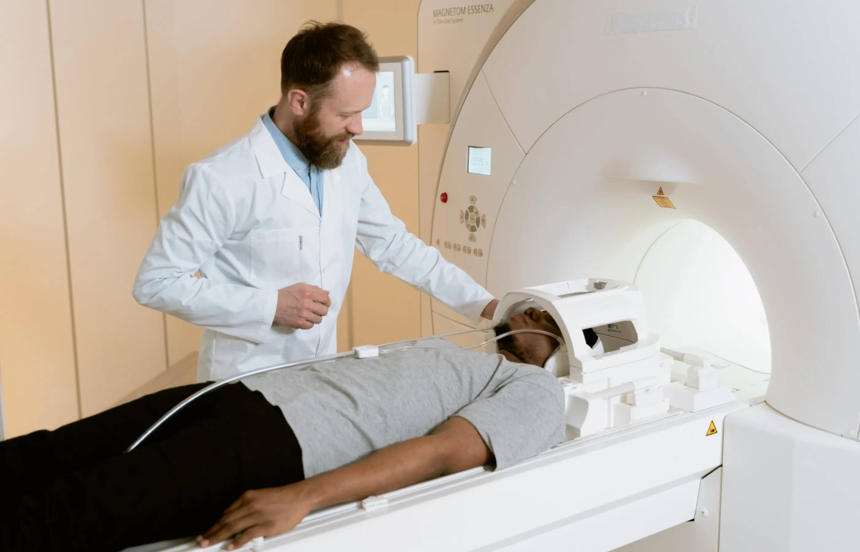 Doctor Looking At Patient Undergoing brain MRI procedure