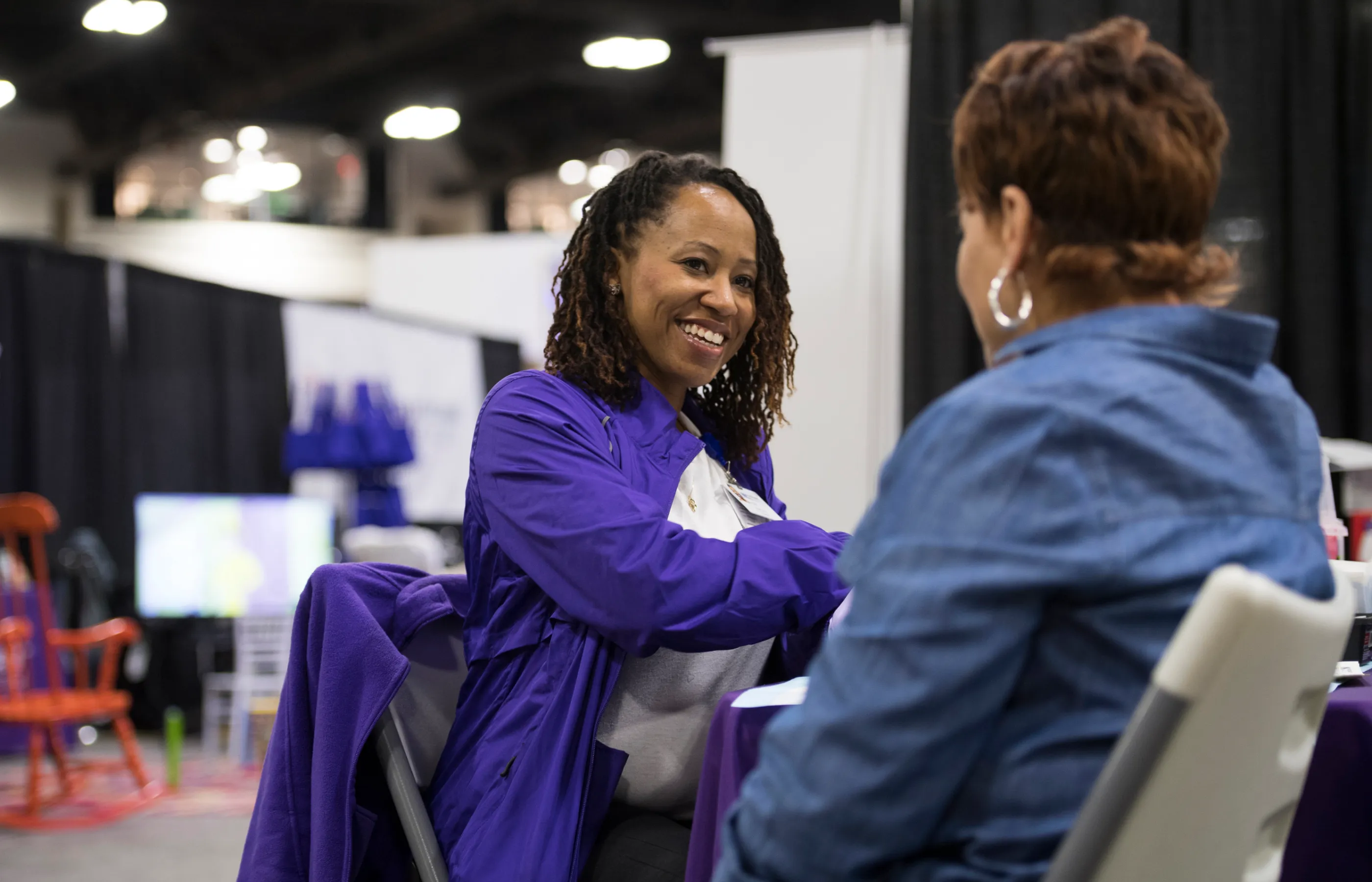 A Novant Health team member is assisting a patient at a community event. 