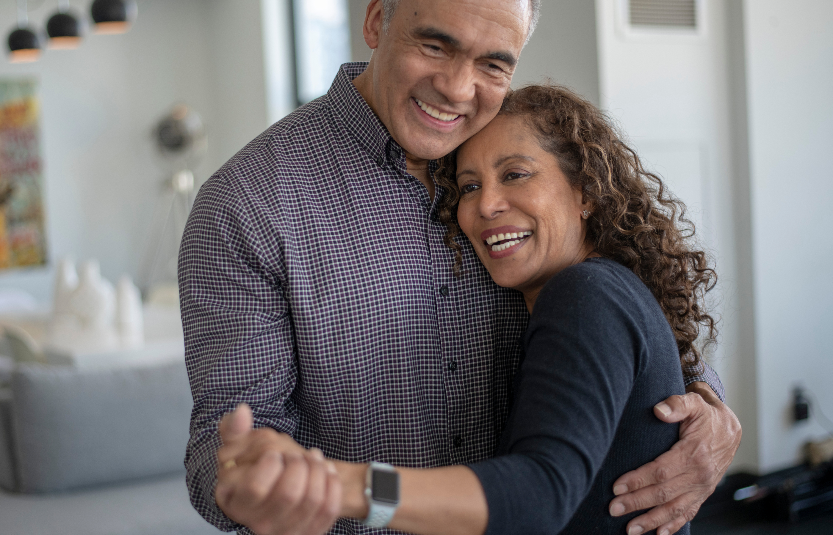 A man and a woman dancing closely at home. A man and a woman dancing closely at home.