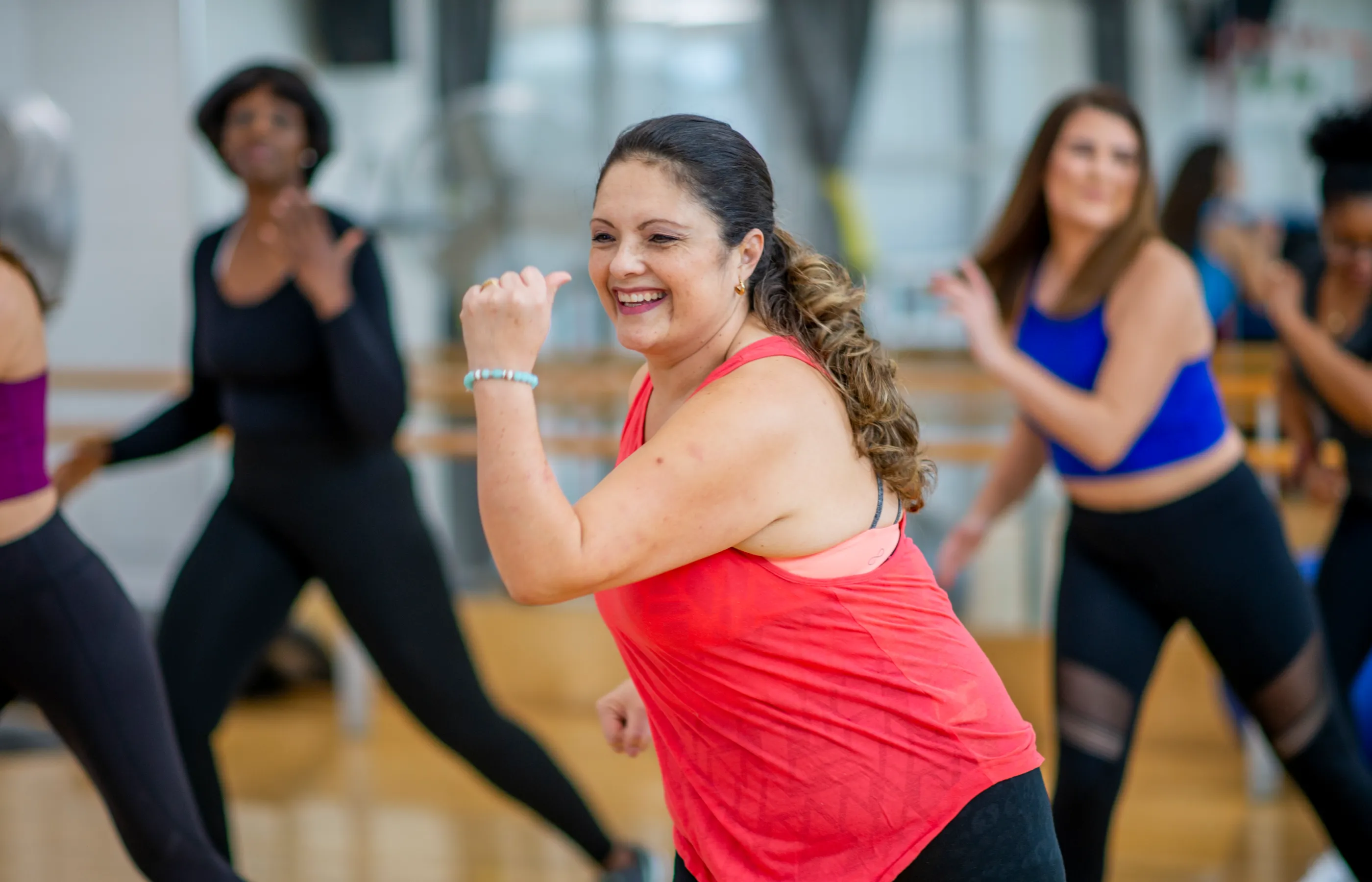  Group of women participating in a fitness dance class