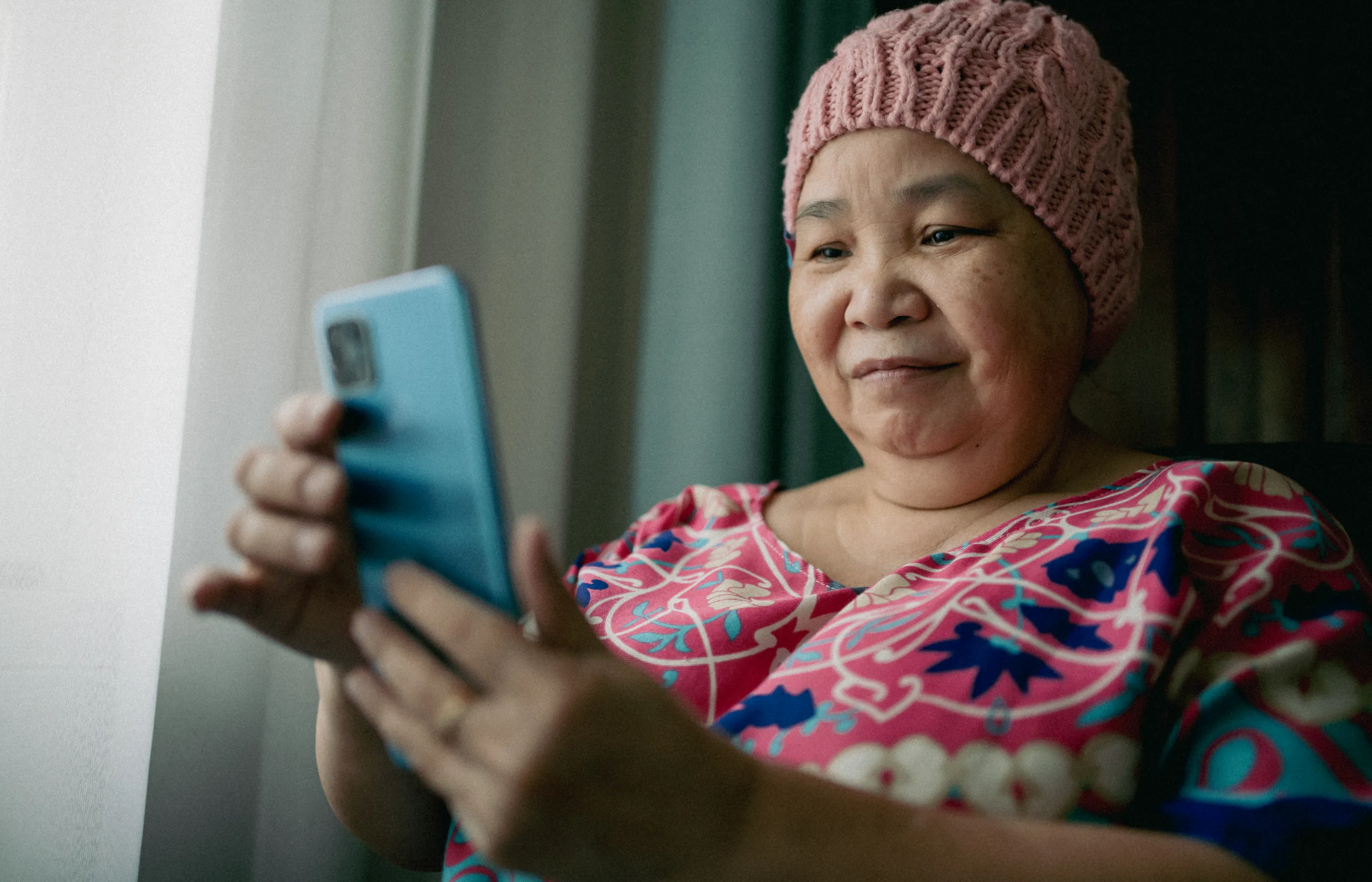 Cancer patient reading and reviewing information on her smartphone. Cancer patient reading and reviewing information on her smartphone.