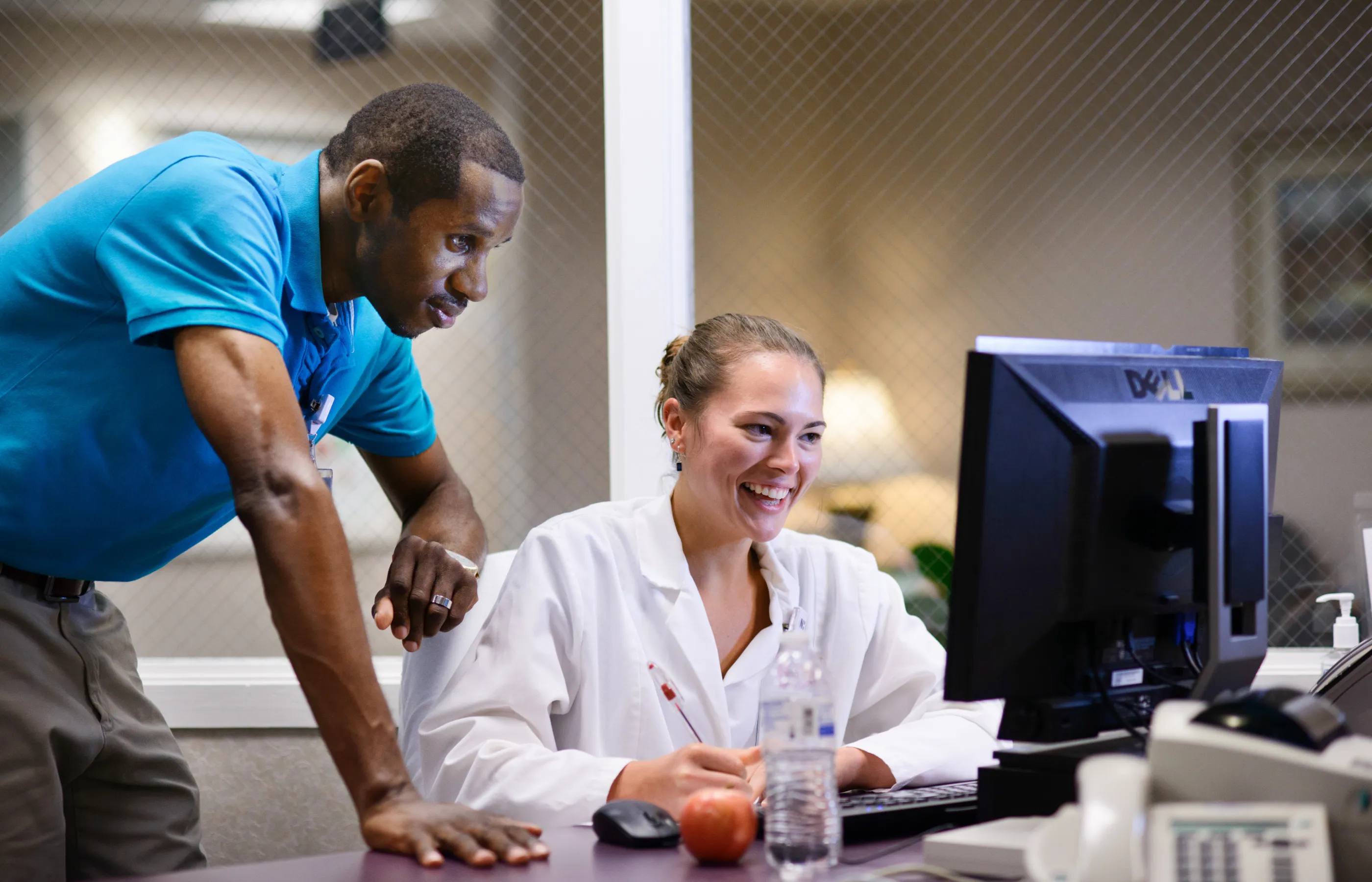 Two team members working at computer in the hospital Two team members working at computer in the hospital
