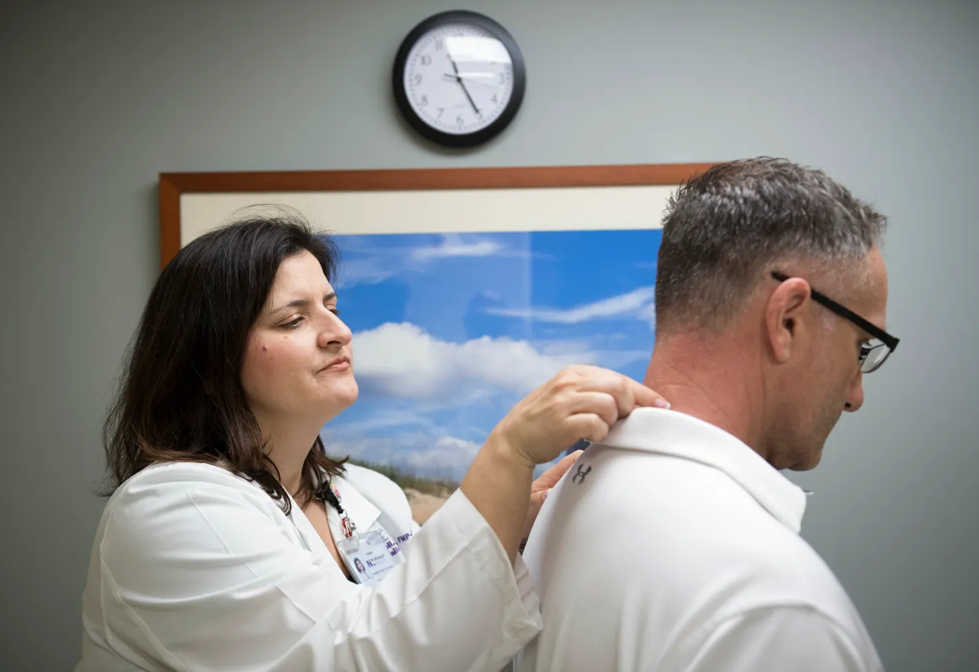 Dr. Mattoli examining a patients neck and spine. Dr. Mattoli examining a patients neck and spine.