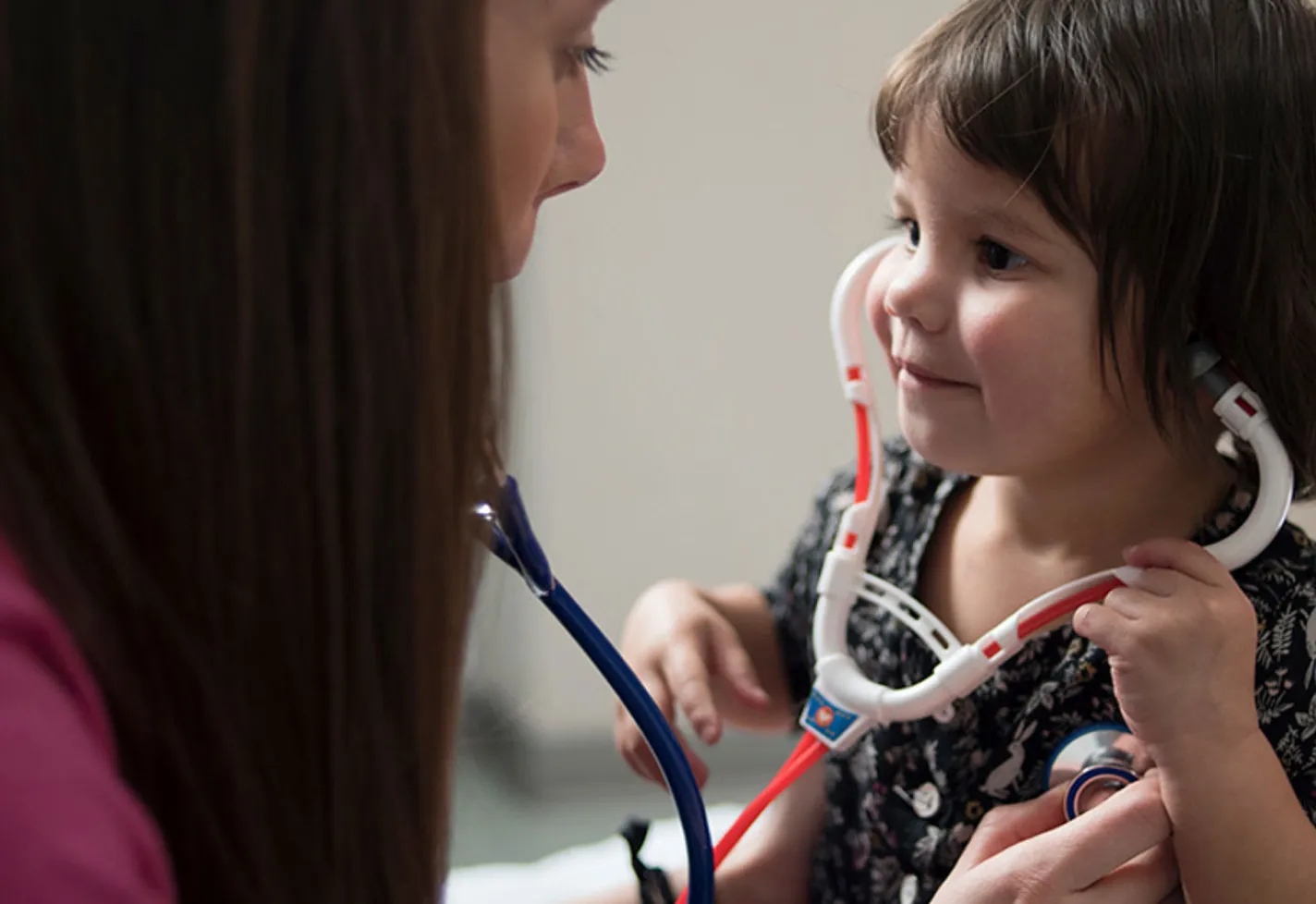 A young girl playing with a toy stethoscope. A young girl playing with a toy stethoscope.
